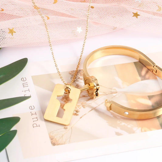 Stainless Steel Couples Lock Bracelet & Key Necklace Set.